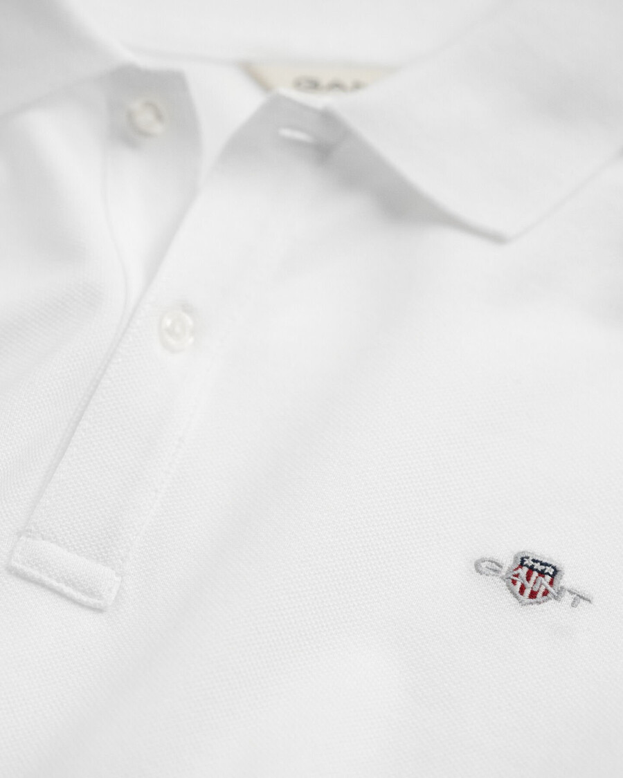 polo de piqué con escudo para adolescentes - blanco